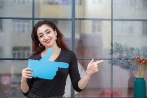young-beautiful-girl-holding-hand-sign-point-it-aside-high-quality-photo_144627-74712