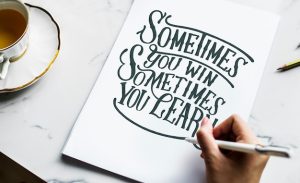 artist-creating-hand-lettering-artwork_53876-105705