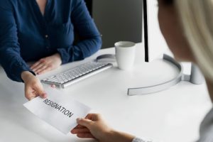 hands-holding-resignation-note-high-angle_23-2149480621