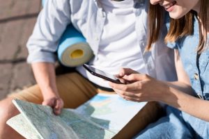 tourist-couple-looking-phone-map_23-2148619900