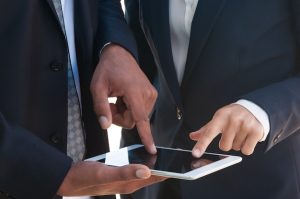 two-businesspeople-using-tablet-together_1262-19425