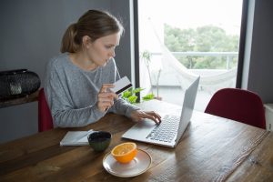 young-woman-making-online-shopping-with-credit-card-pc_1262-18800