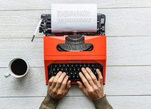 aerial-view-man-typing-retro-typewriter_53876-40994-3