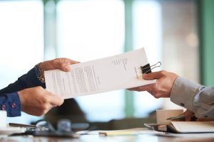 closeup-hands-passing-contract-unrecognizable-businessman_1098-19612-11