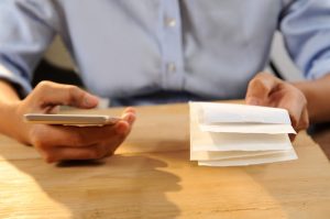 closeup-person-calculating-paying-bills_1262-14859-3