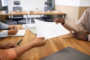 man-holding-contract-his-new-office-job-after-interview_23-2149034567-3